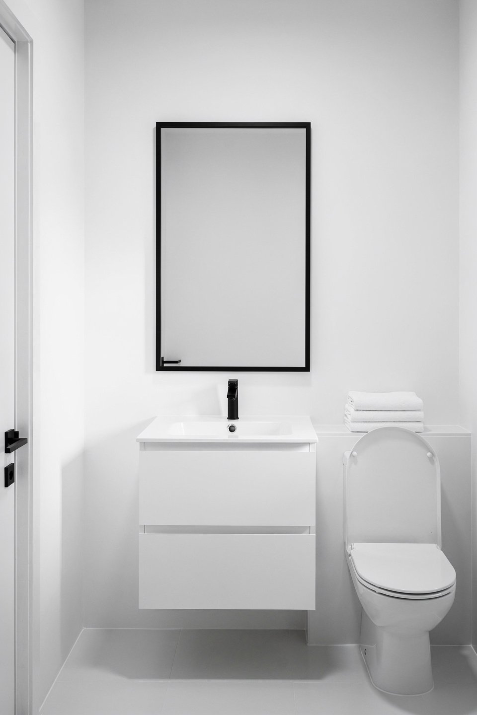 minimalist black and white bathroom clean white walls simple white toilet and si 0